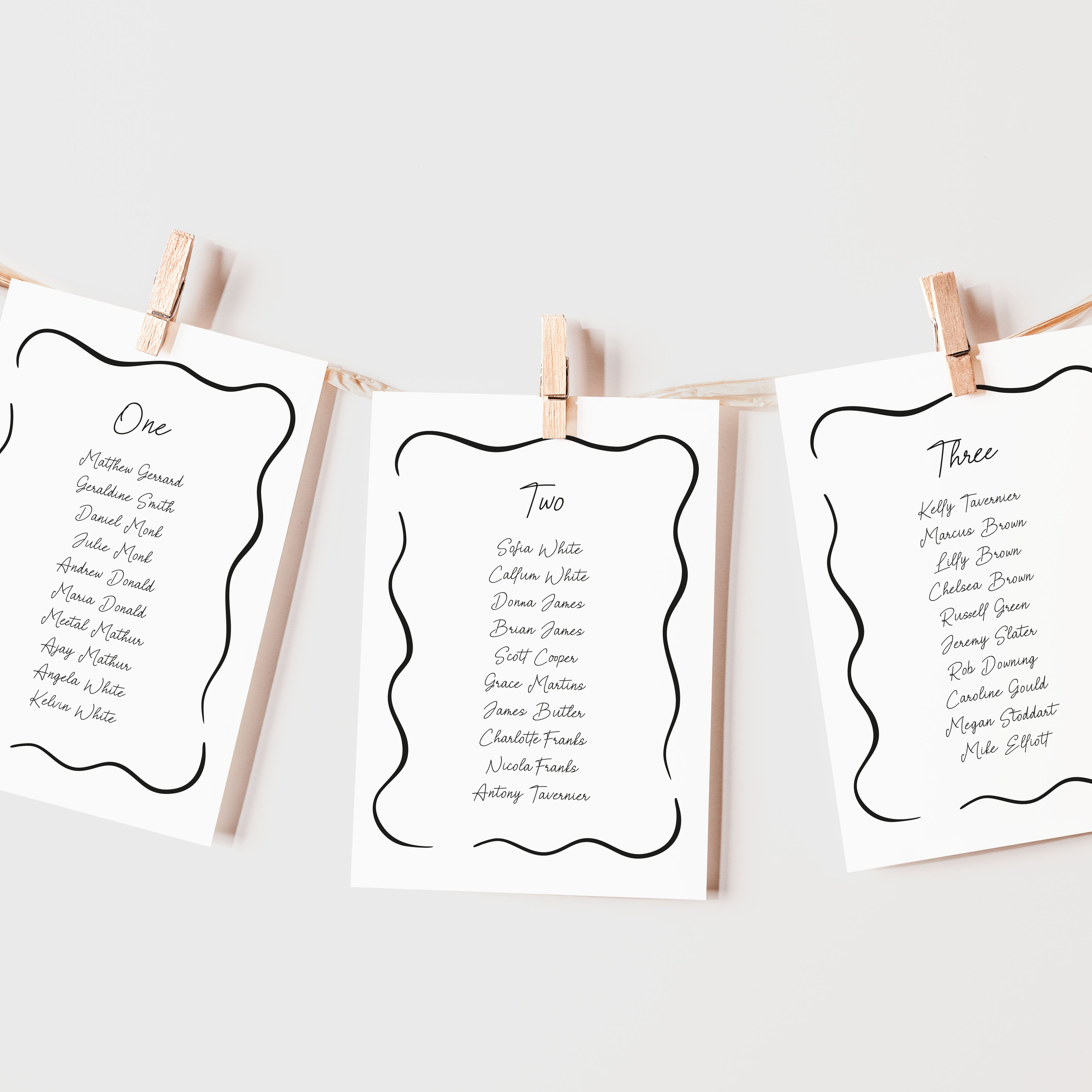 Hanging seating plan cards for a wedding with a whimsical design