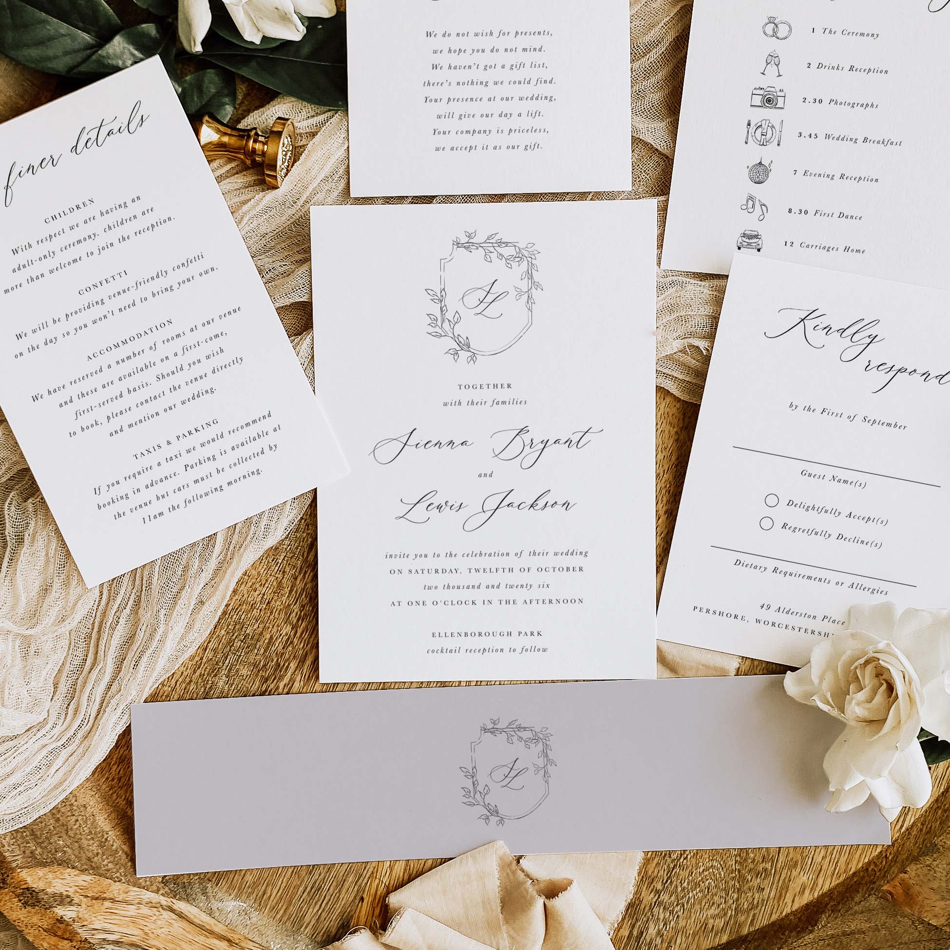 Wedding invitation with information cards and belly band on a natural surface