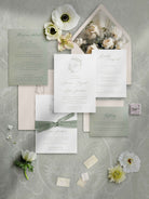 Wedding invitation set with floral elements on a textured gray background