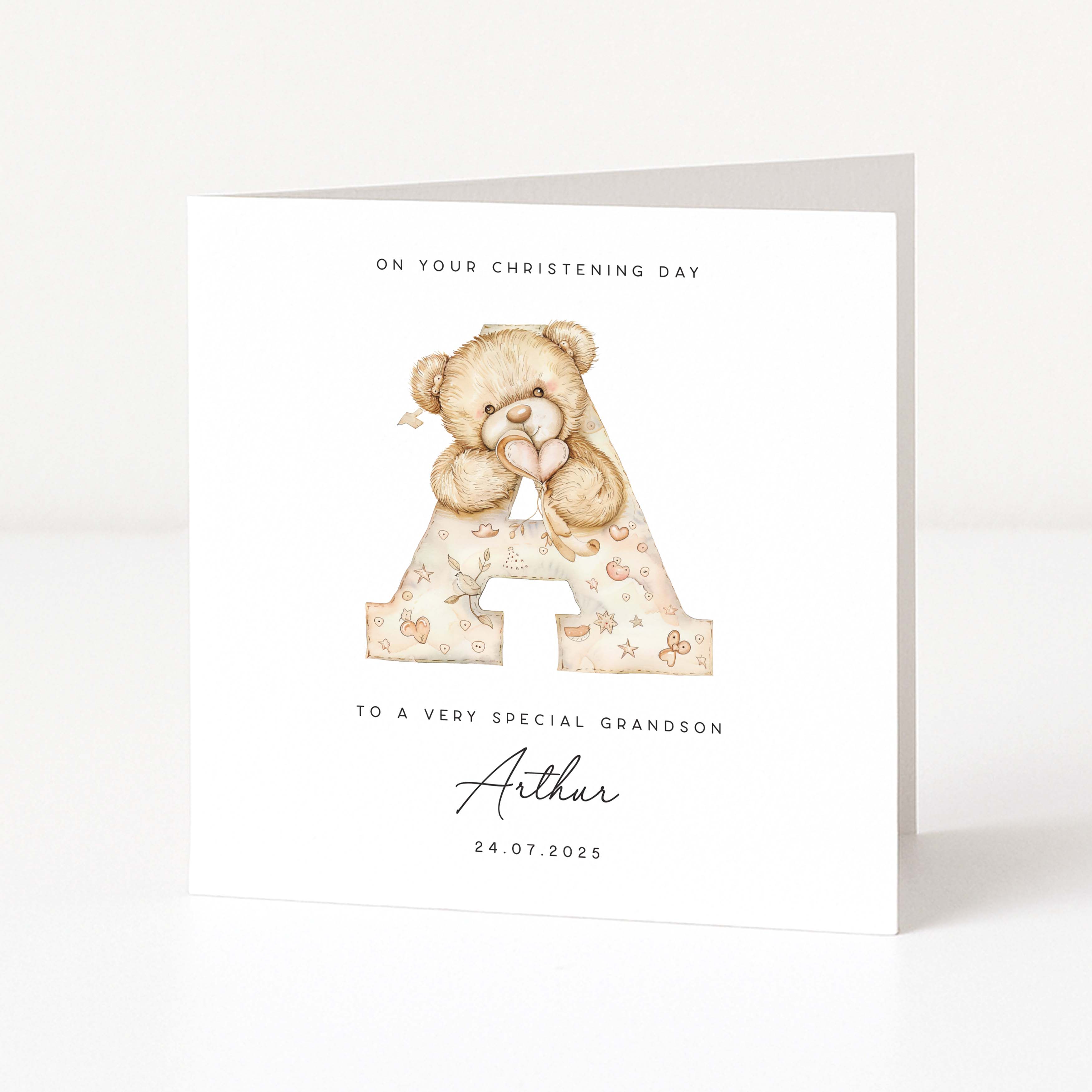 Personalised christening card for grandson with teddy bear holding letter 'A' on a white background