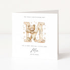 Personalised christening card for girl with teddy bear and letter 'M' design on a white background