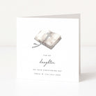 Christening card for daughter with a cross and bible design and personalized text on a white background