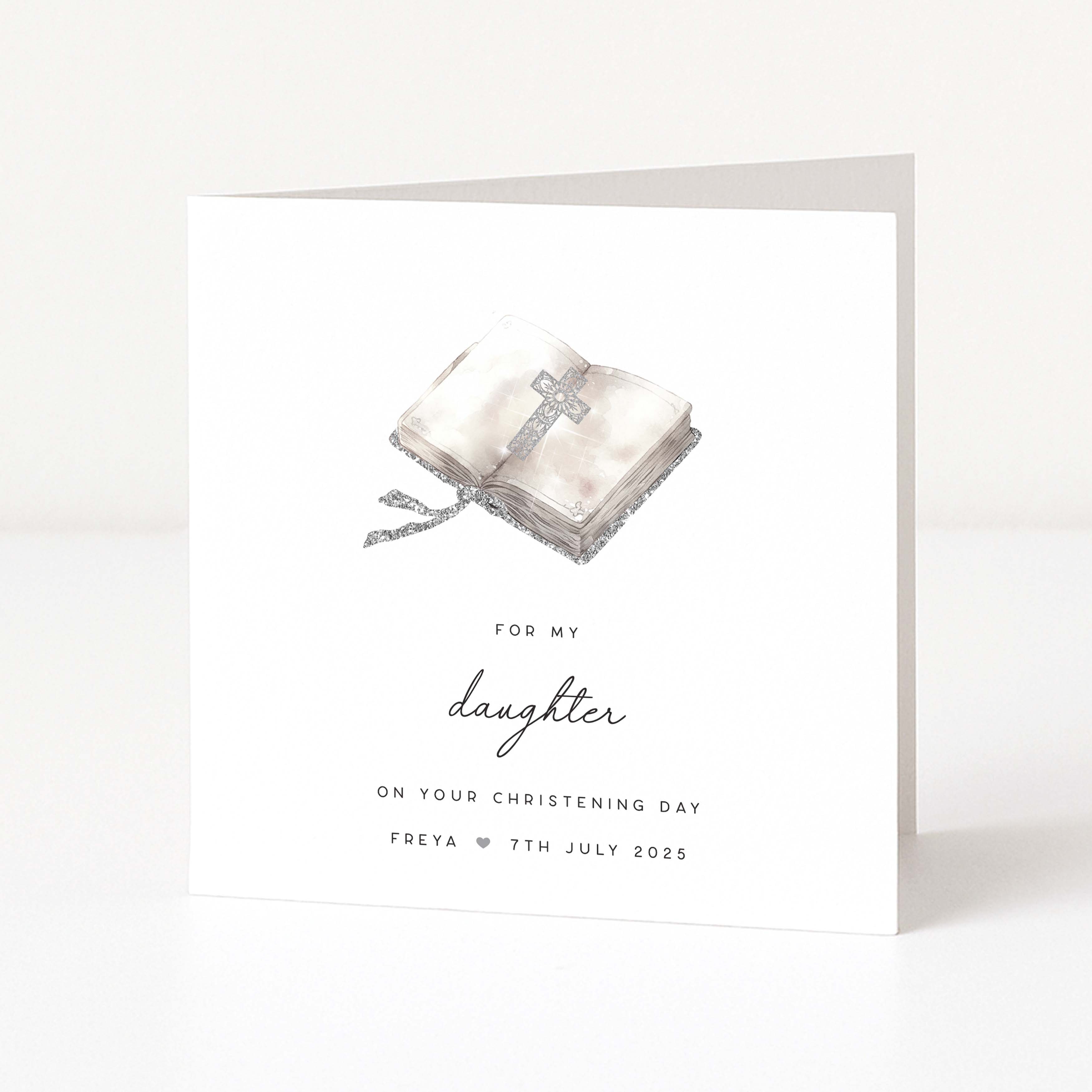 Christening card for daughter with a cross and bible design and personalized text on a white background