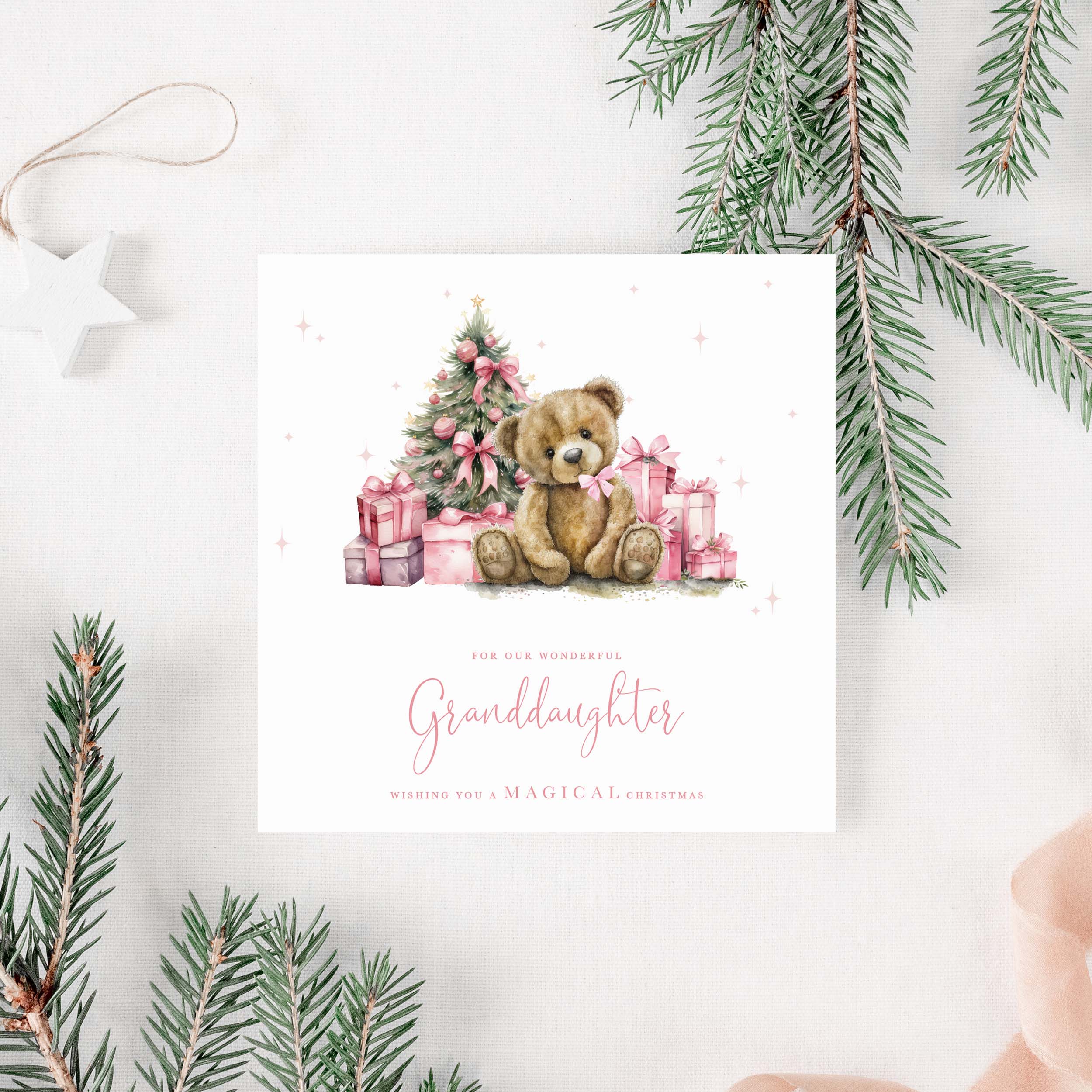 Christmas card for granddaughter with a teddy bear and tree surrounded by presents, surrounded by Christmas decorations.