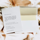 Wedding invitation card with envelope on a textured surface