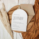 Arched Wedding invitation card with envelope on a textured surface with pampas grass