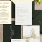 Collection of wedding invitations with text and decorative elements on a textured surface.