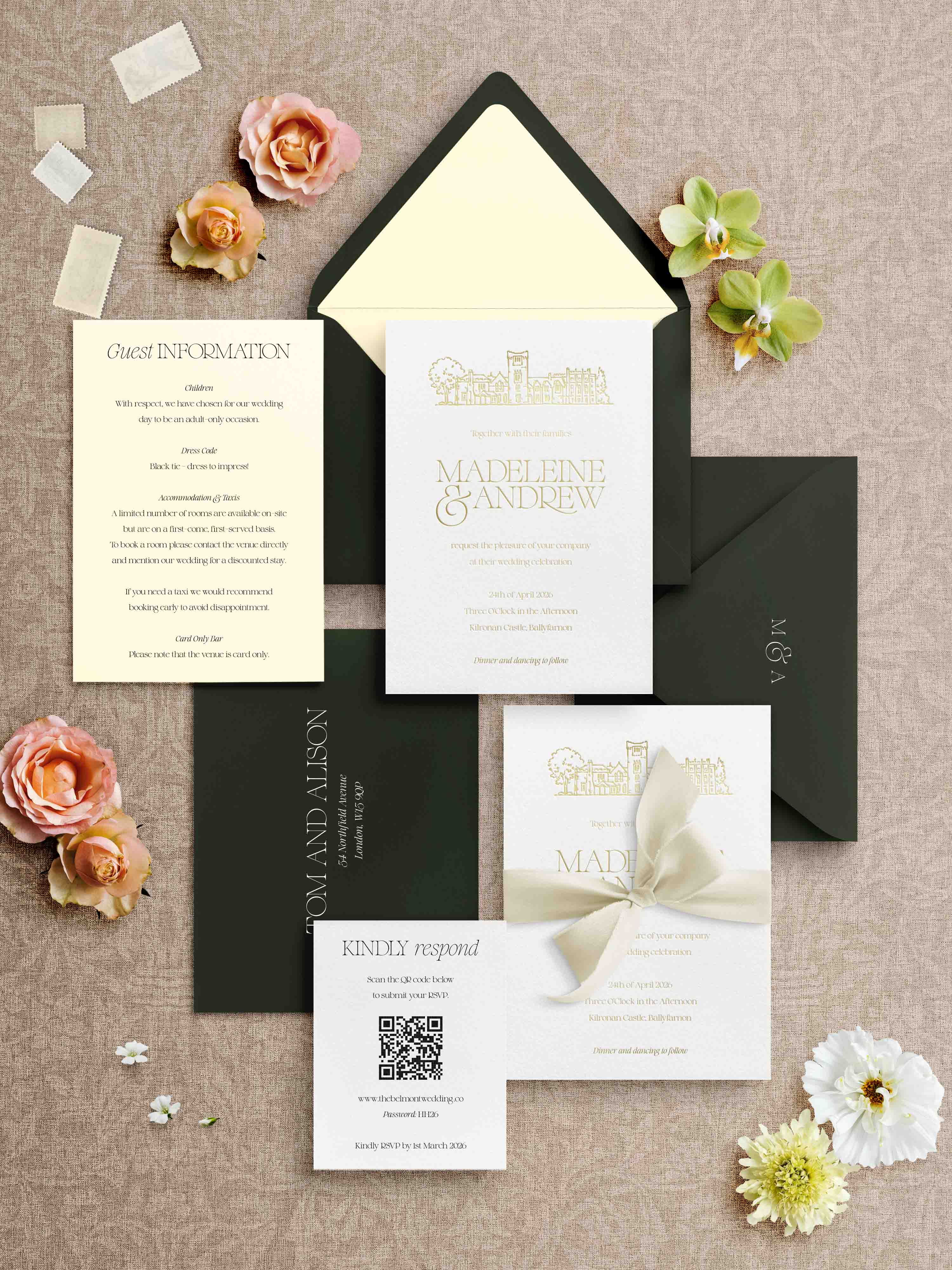 Foiled Wedding invitation set with venue illustration and envelopes and floral decorations on a textured surface