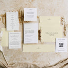 Wedding invitation set with envelopes and cards on a textured surface