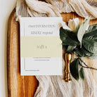 Wedding invitation card on a wooden board with floral decorations