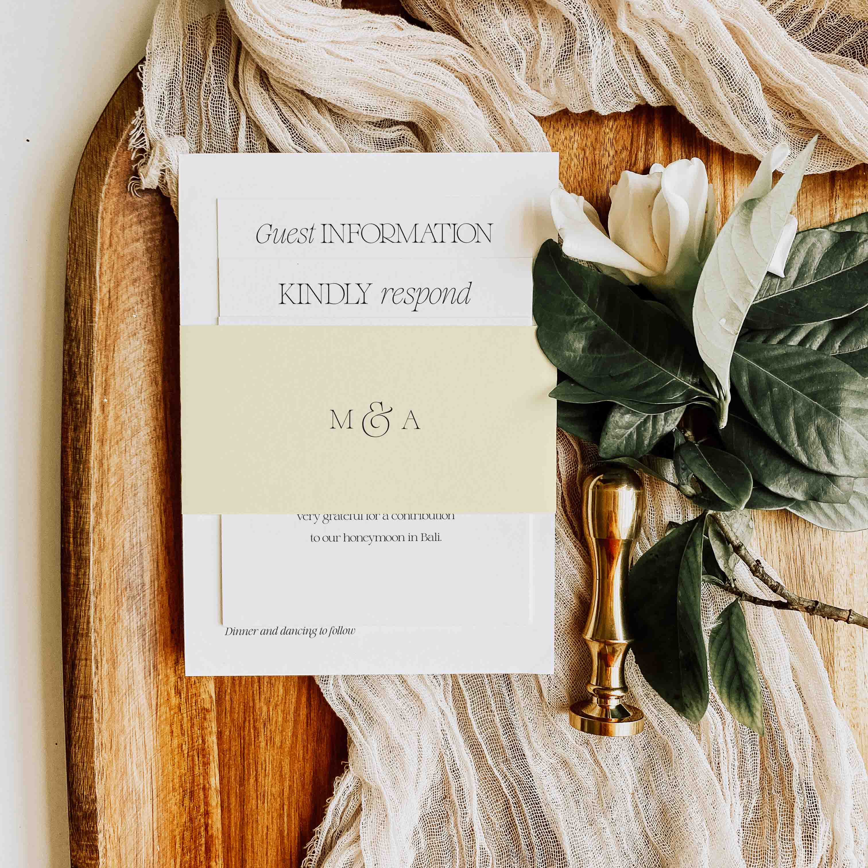 Wedding invitation card on a wooden board with floral decorations