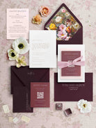 Letterpress Wedding invitation set with floral elements on a textured surface