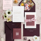 Letterpress Wedding invitation set with floral elements on a textured surface