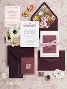Letterpress Wedding invitation set with floral elements on a textured surface