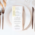 Menu card on a white plate with cutlery