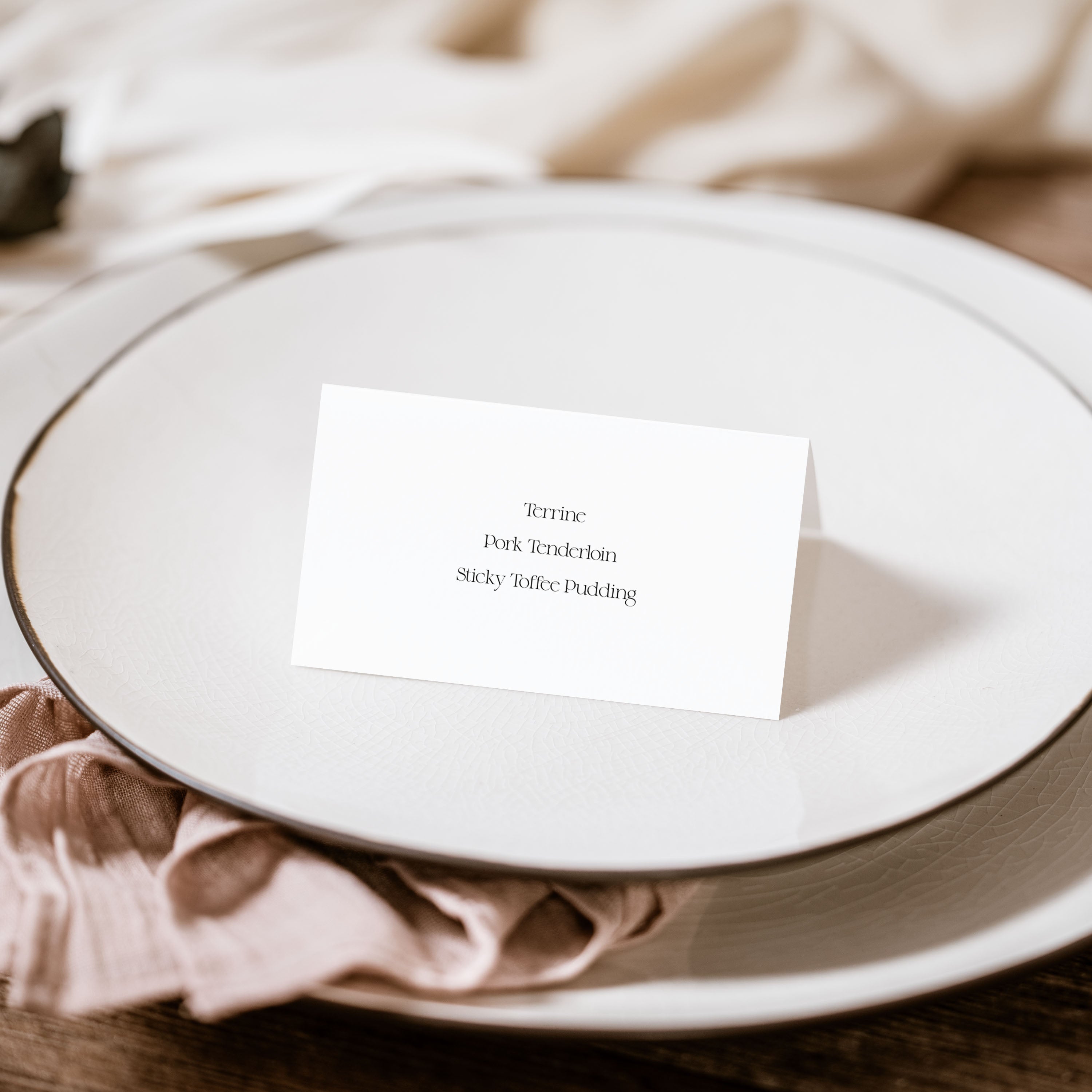 White plate with a menu card on a wooden table