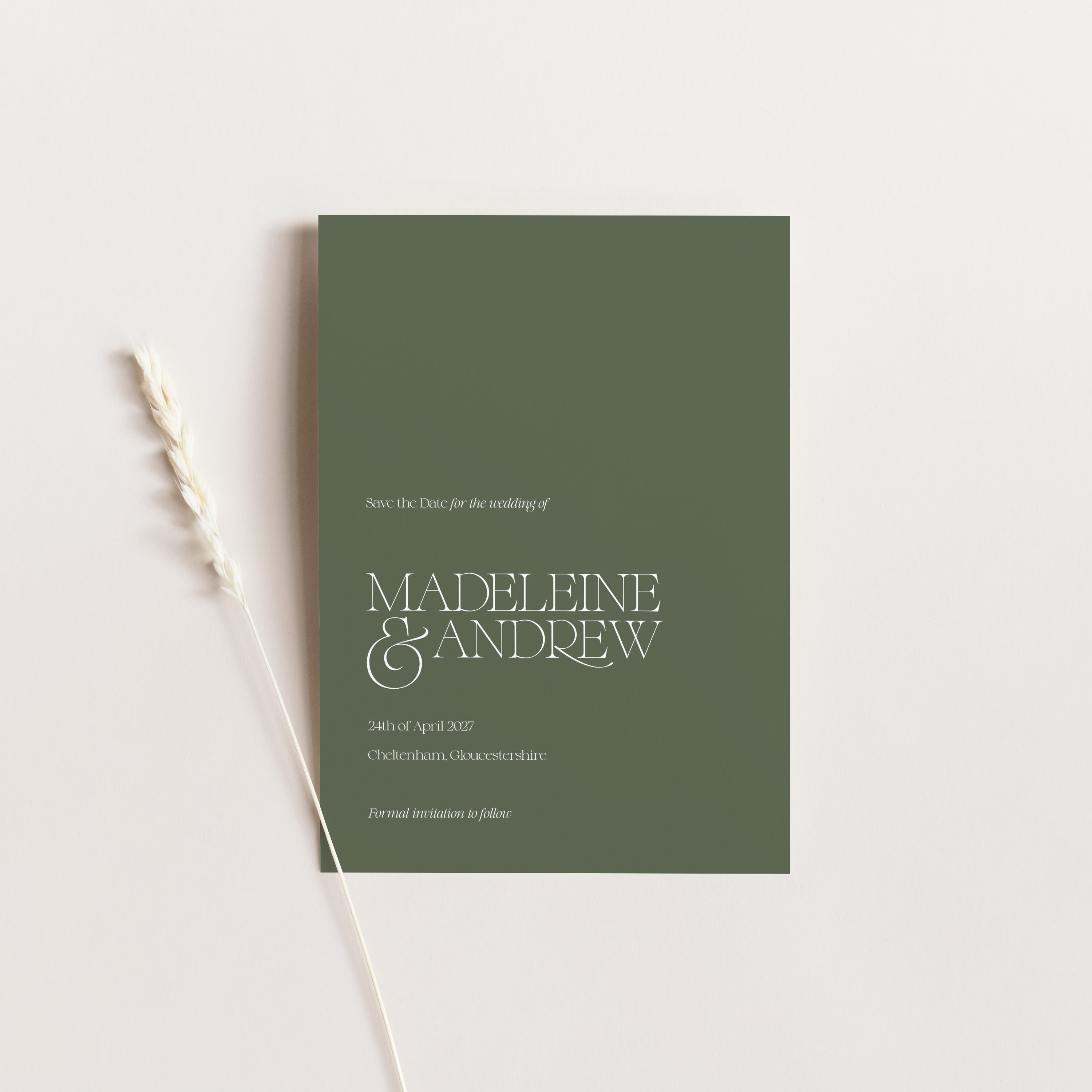 Green wedding save the date card with 'Madeleine & Andrew' on a light gray background