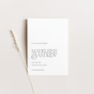 White save the date wedding card with black text on a light gray background