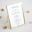 Personalised bar menu for wedding reception in gold frame on neutral background