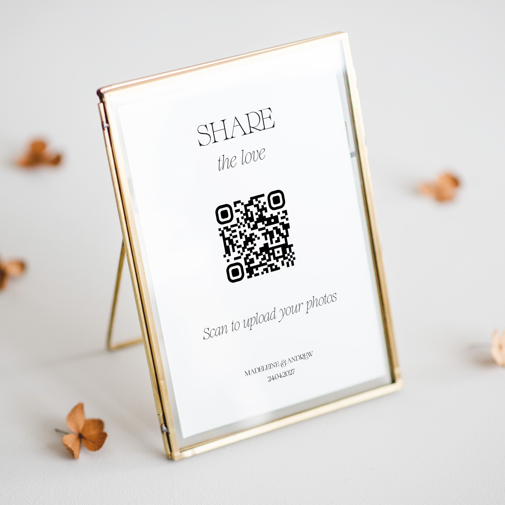 Gold photo frame with QR code for wedding photo upload on a light background