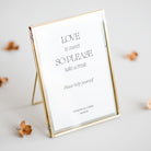 Gold-framed sign for sweet cart at wedding reception with text on a white background