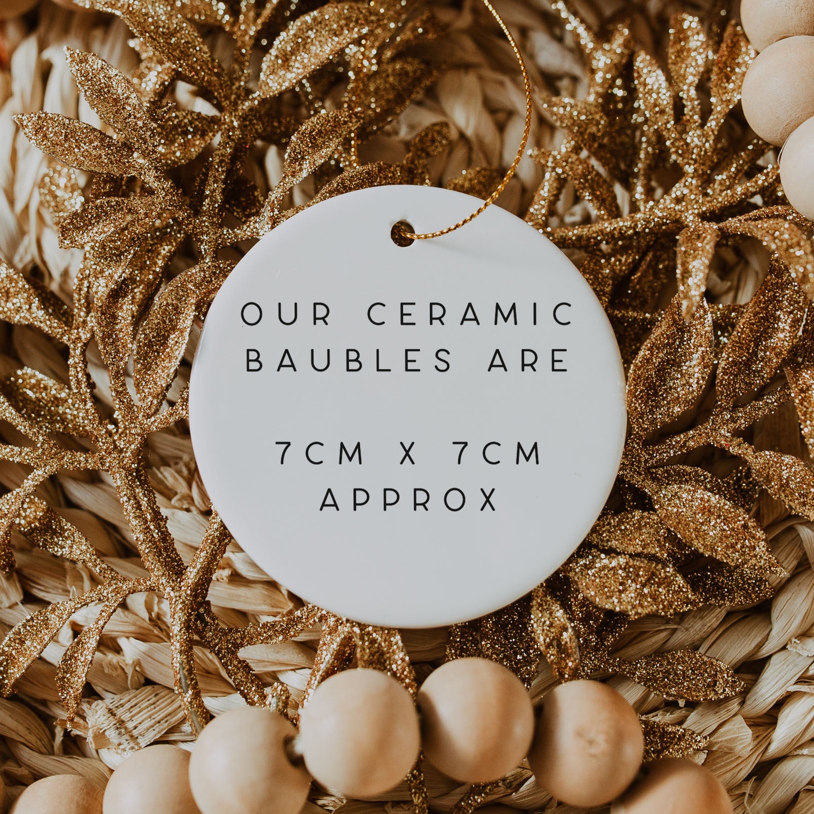 Ceramic bauble with text on a decorative background