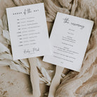 modern wedding programme paddle fan printed double sided with wooden handles on a natural background. 