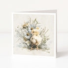 Greeting card with a chick and floral arrangement on a white background