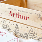 Wooden box with 'A Special Christmas Delivery for Arthur' text and festive illustrations.