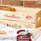 Wooden Christmas box with personalised name 'Charlotte' against a brick wall background.