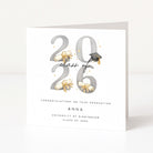 Graduation card with '2026' design, ribbons, and a cap on a white background