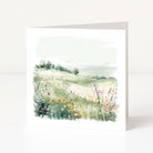 Greeting card with a scenic illustration of a field and trees on a white background