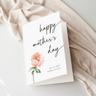 Mother's Day card with a pink flower on a soft fabric background