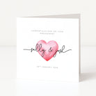 Engagement card with a pink heart and personalized names on a white background