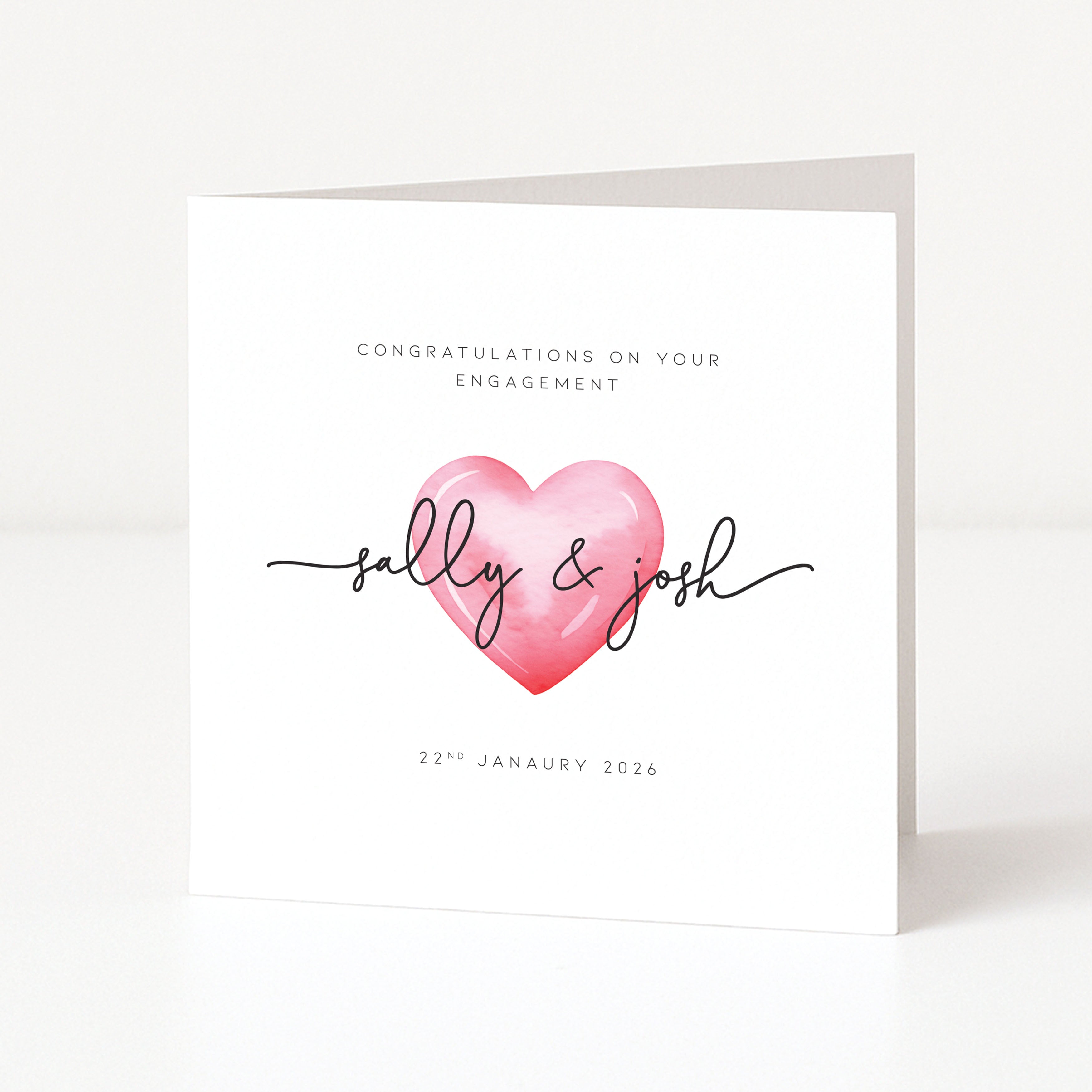 Engagement card with a pink heart and personalized names on a white background