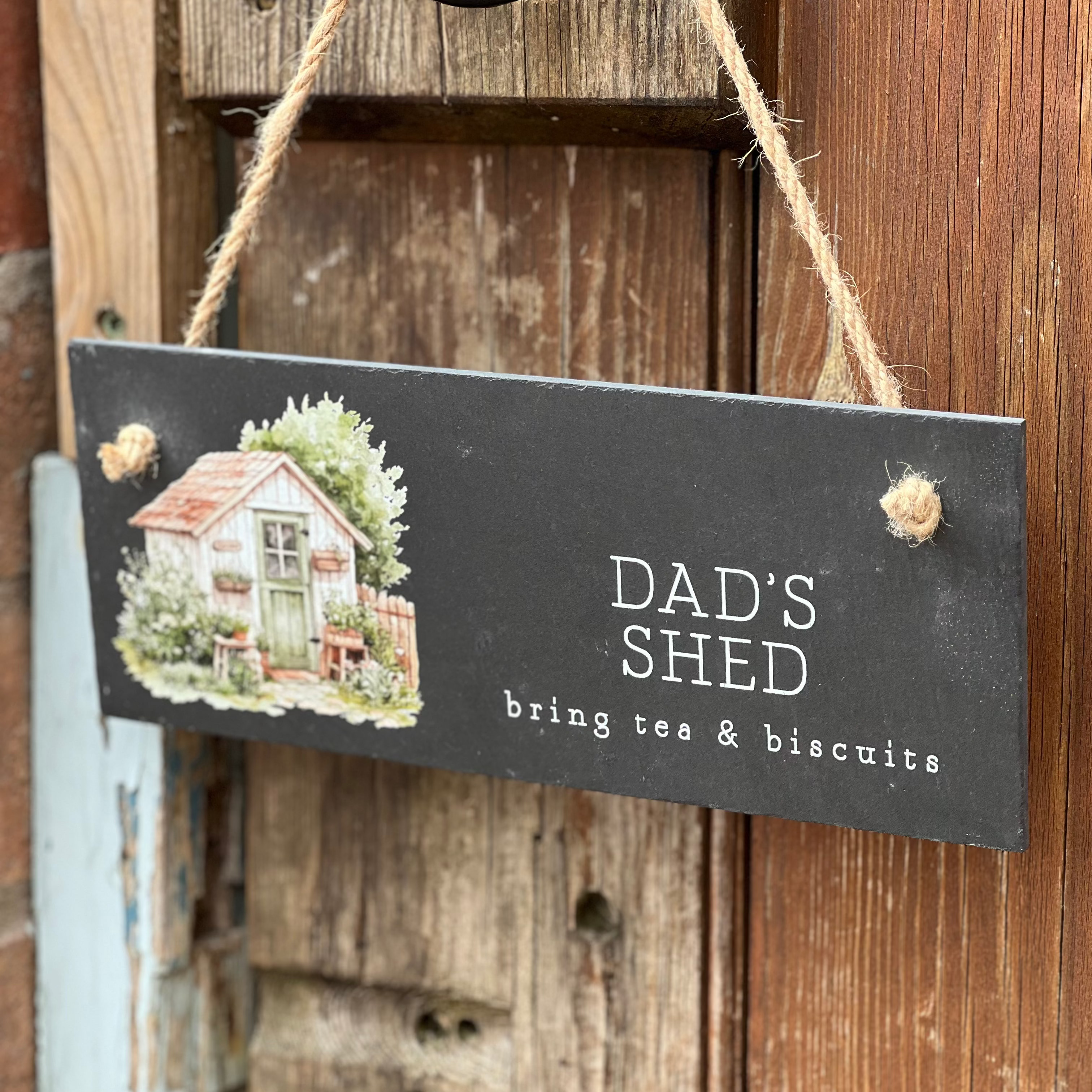 slate sign on rustic door with dad shed written on it