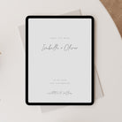 Digital tablet displaying a minimalist wedding save the date design with 'Isabelle + Oliver' on a light background.