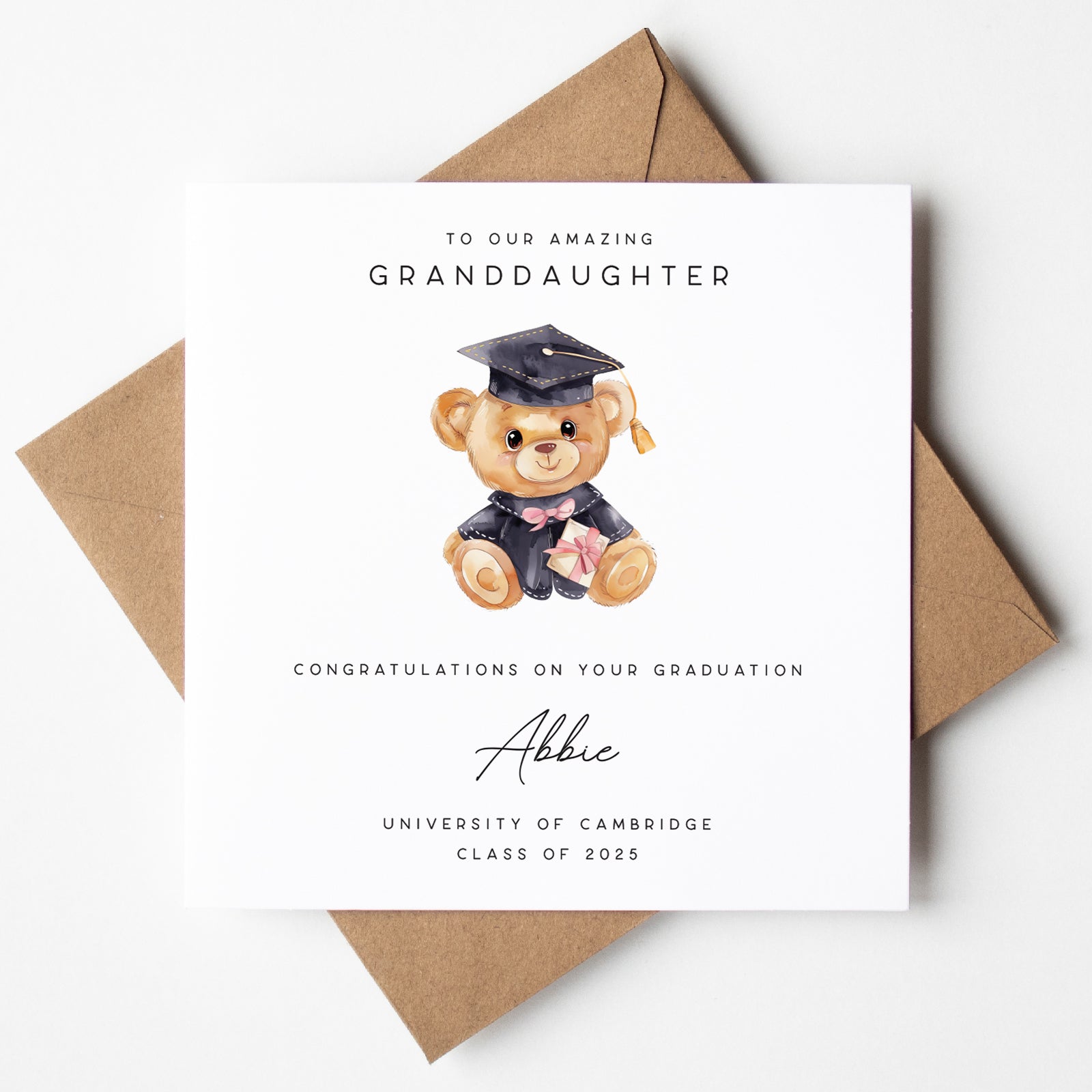 Graduation card with a teddy bear illustration and personalized text on a white background.