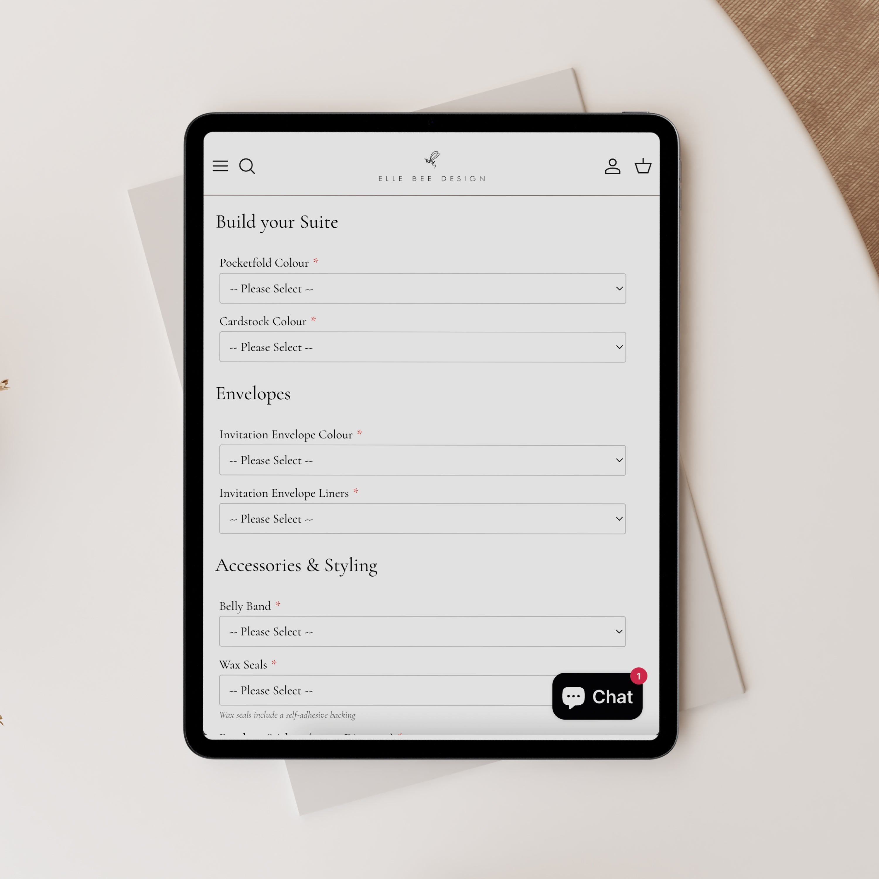 Tablet displaying a customisation interface for wedding stationery via Elle Bee Design website on a light surface.