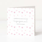 Greeting card with pink heart pattern and 'Congratulations on your Engagement' text.