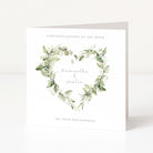 Engagement card with green leaf wreaths and personalized names on a white background