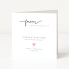 Engagement card with 'forever has a nice ring to it' text and a pink heart on a white background