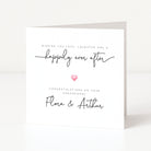Engagement card with 'happily ever after' text and a heart symbol on a white background