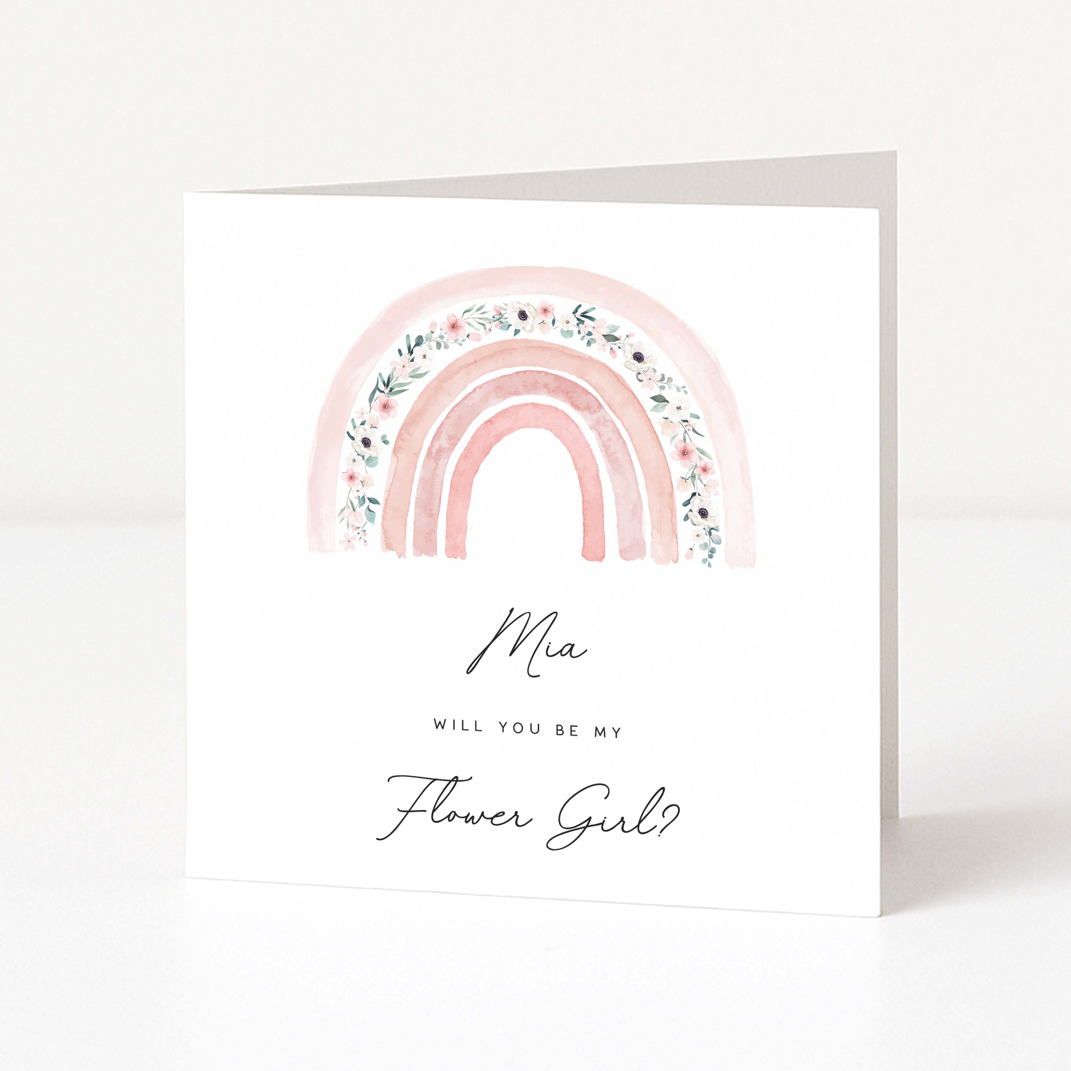 Greeting card with pink rainbow and floral design, asking if 'Mia' will be the flower girl.