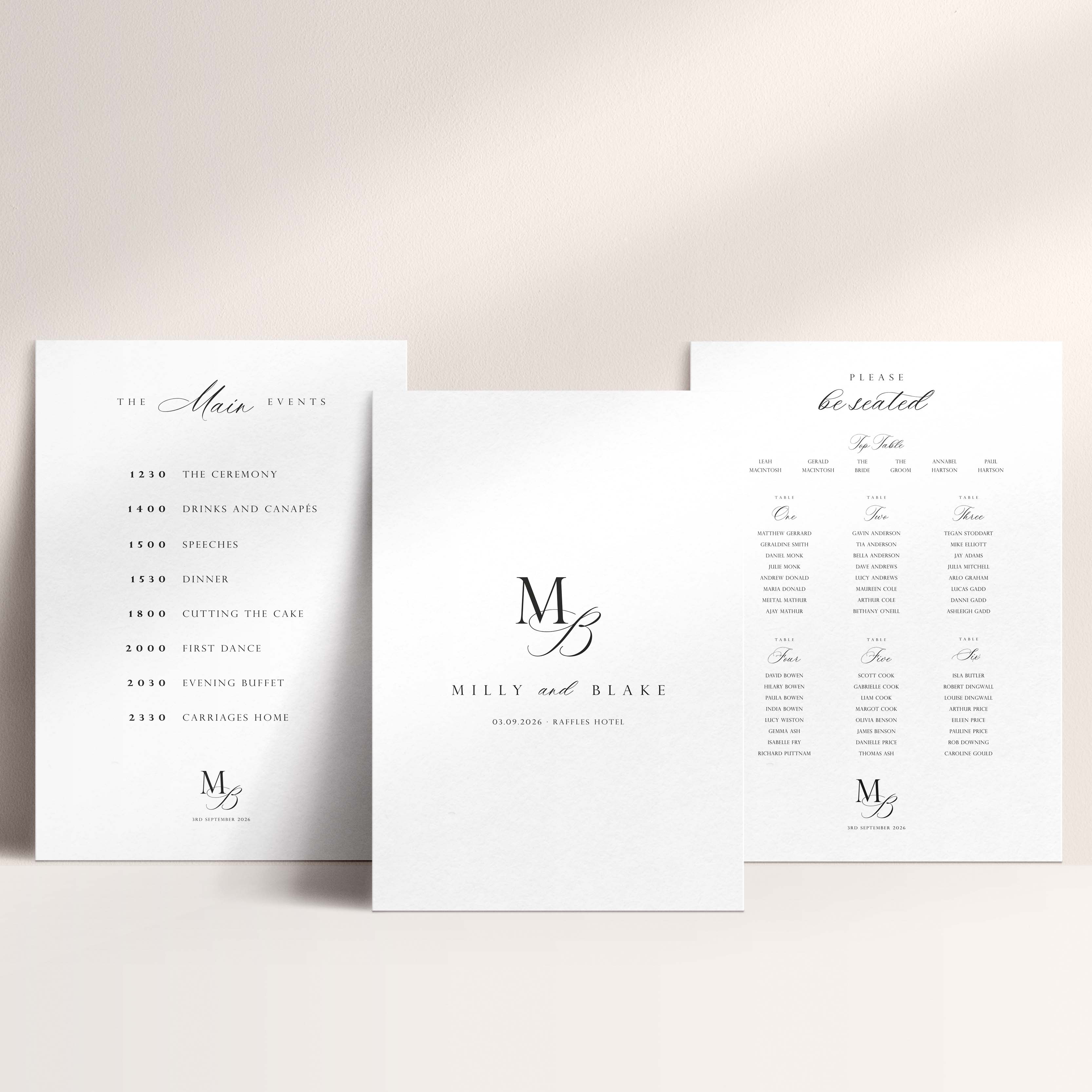 Three white wedding signs in a coordinated design showing an itinerary, welcome sign and seating chart against a neutral background