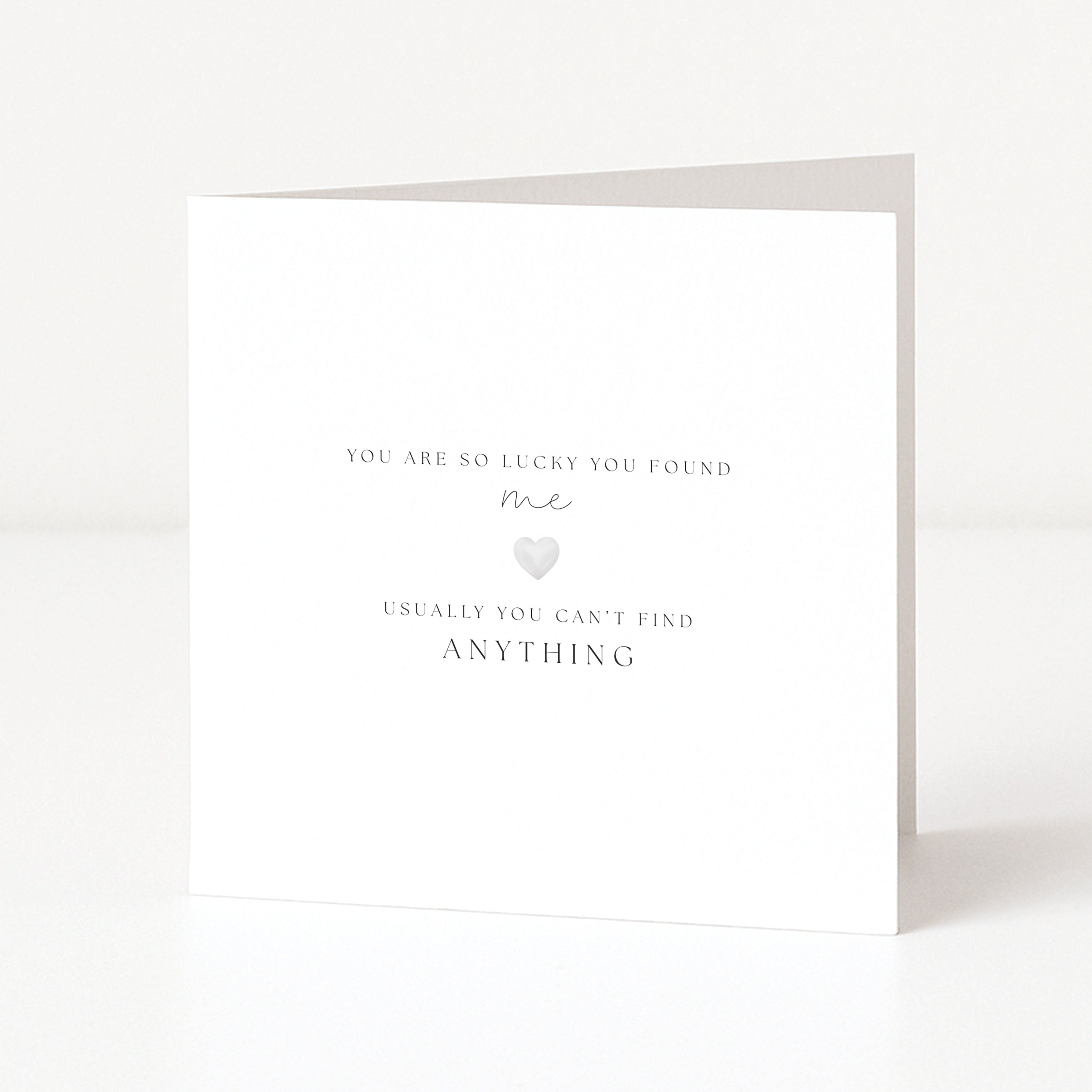 White greeting card with text and a heart symbol on a white background