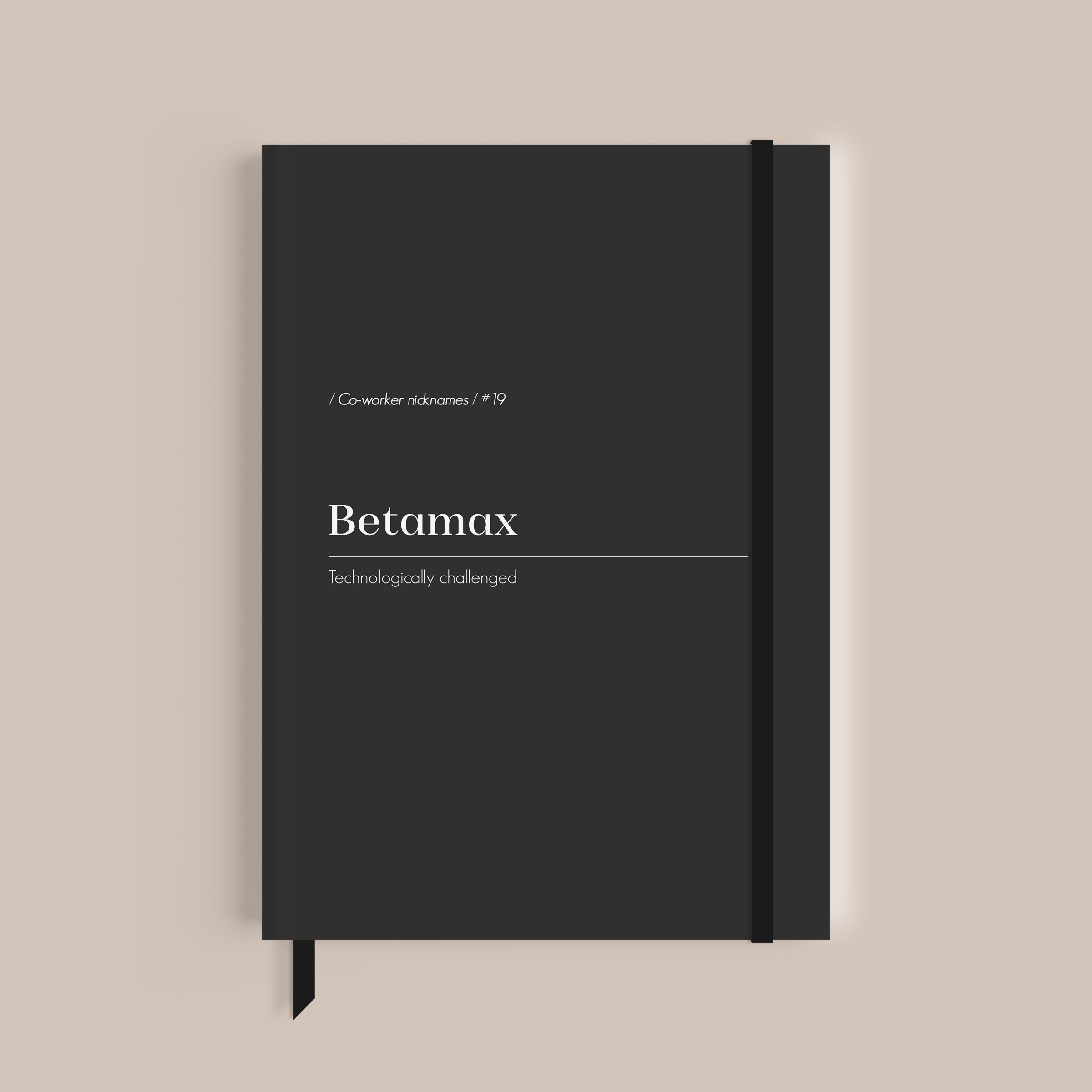 Black notebook with white text on a beige background