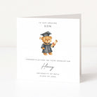 Graduation card with a teddy bear holding a diploma on a white background