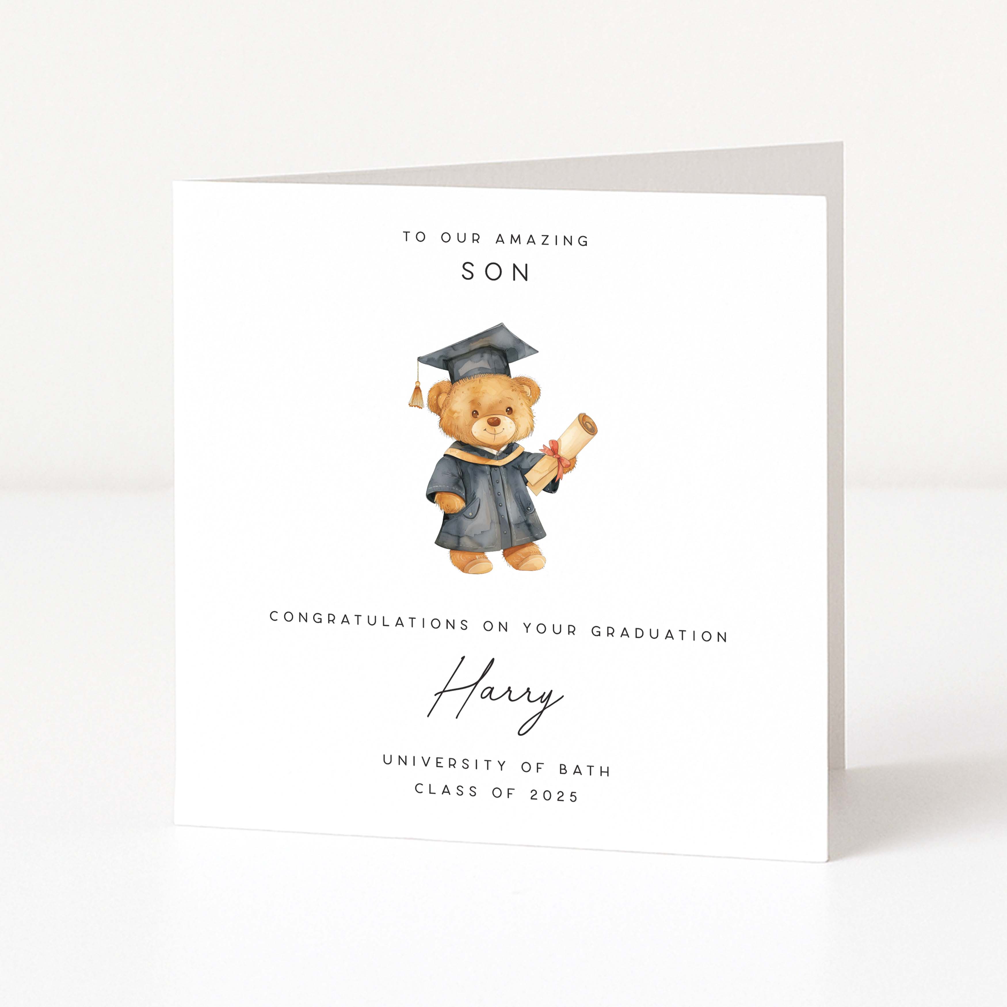 Graduation card with a teddy bear holding a diploma on a white background