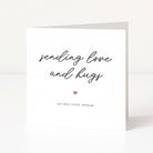 Greeting card with 'sending love and hugs' text and a heart symbol on a white background